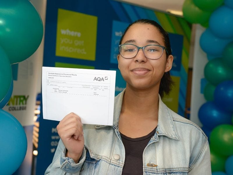 Coventry College student holding GCSE results certificate