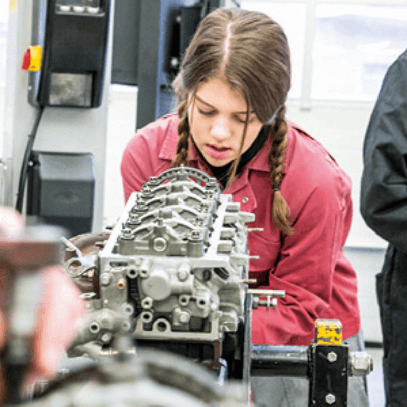 Image of motor vehicle learner working on car parts
