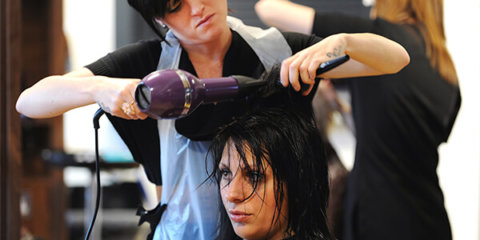 Hair & Beauty learner drying a customer's hair