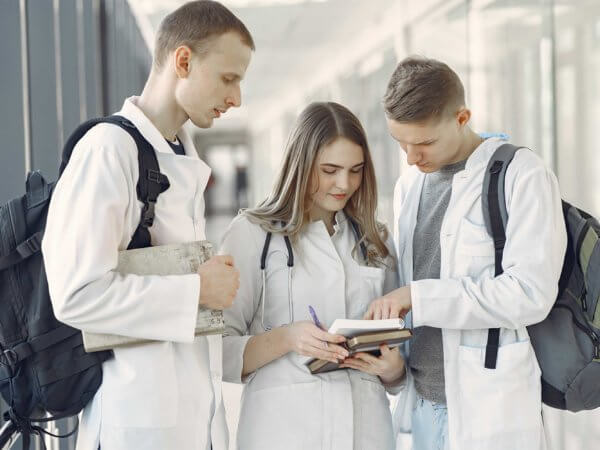 Medical students looking at a notebook