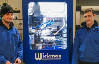 Mason busby and danny leedham standing next to wickman branded machinery