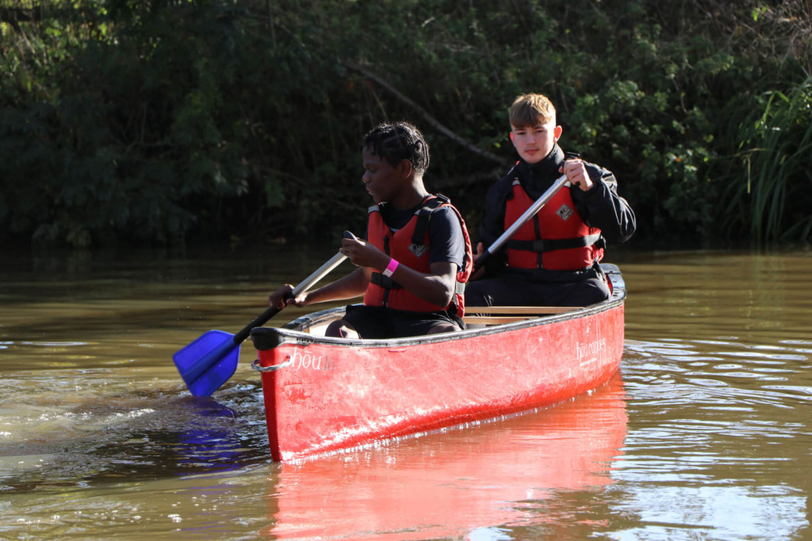 Image of two young people in a canoe