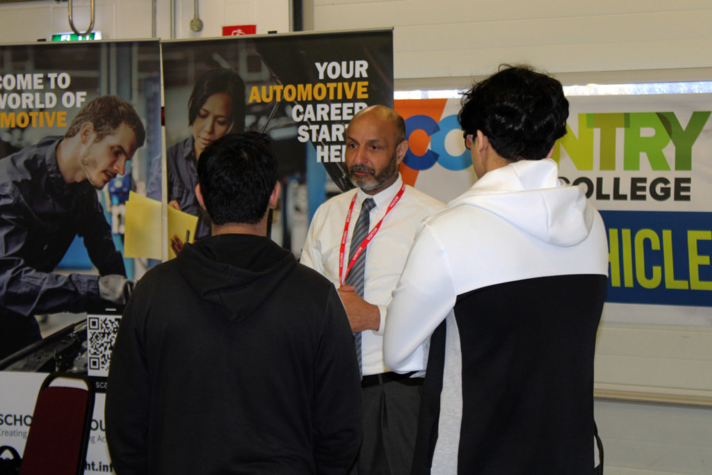 Learning speaking to employers at a motor vehicle careers fair