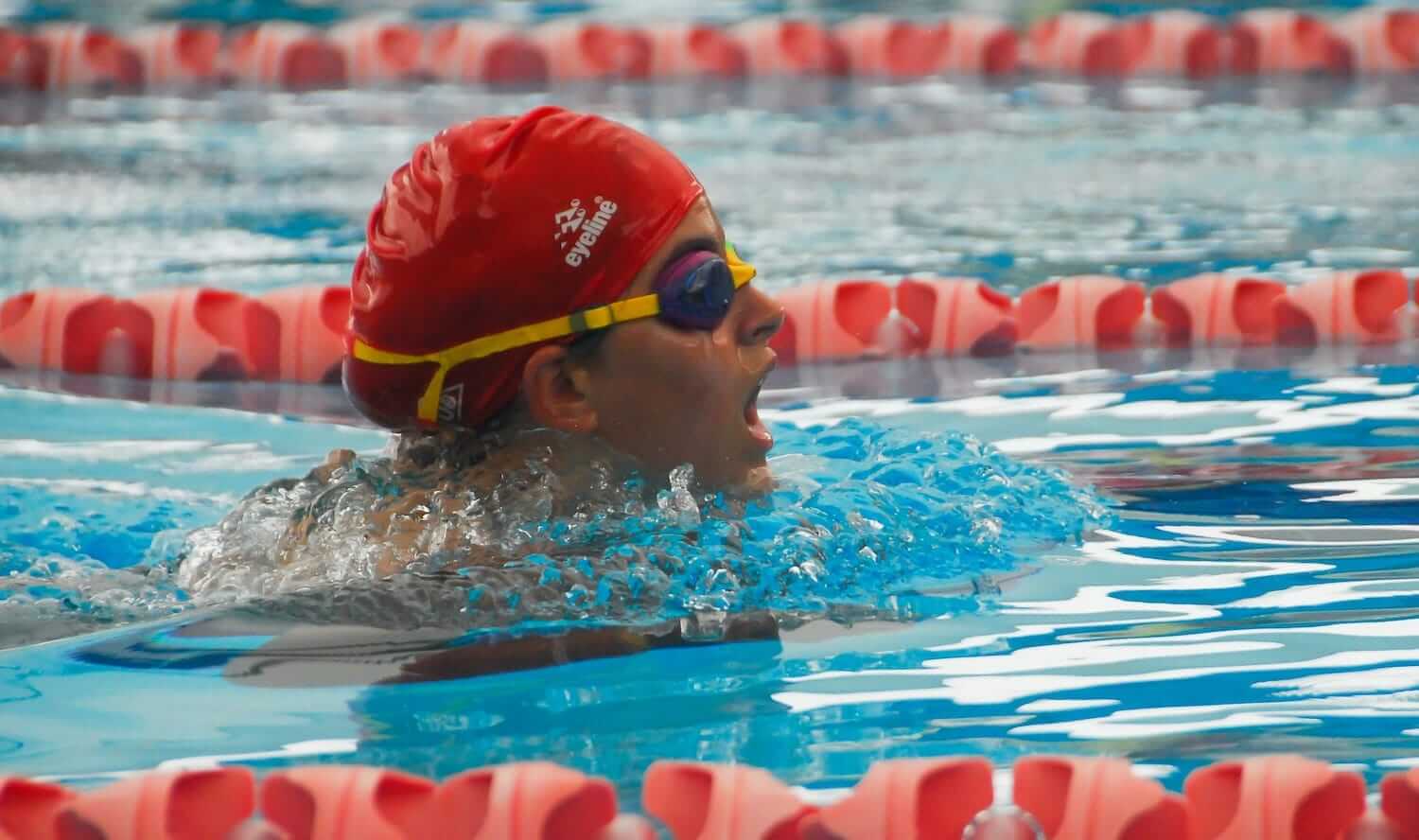 Person Wearing Swimming Cap and Goggles