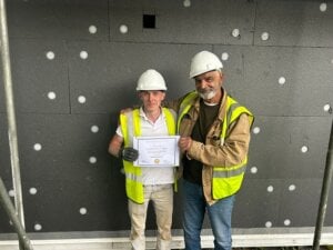 Students training with partners in retrofitting as part of the social housing decarbonisation project