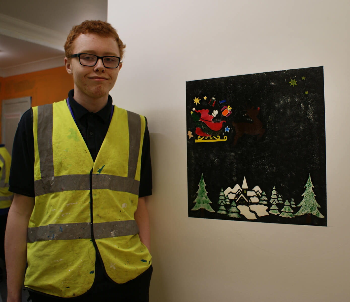 Level 1 Painting and Decorating student standing next to winning stencil entry