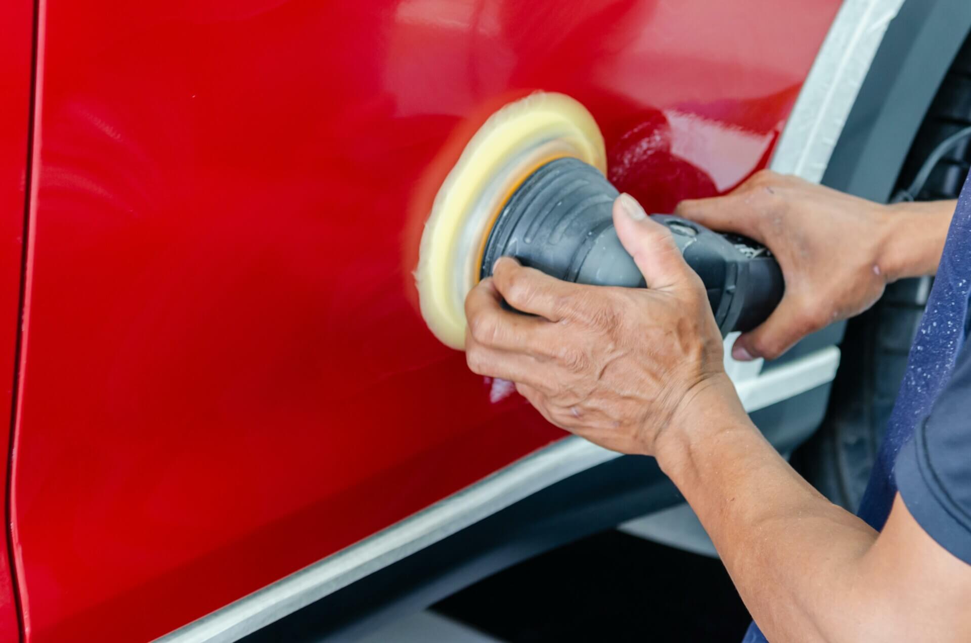 Person polshing red car