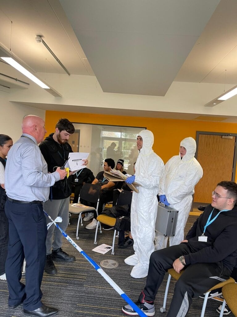 Forensics Public Services wearing white forensics suits