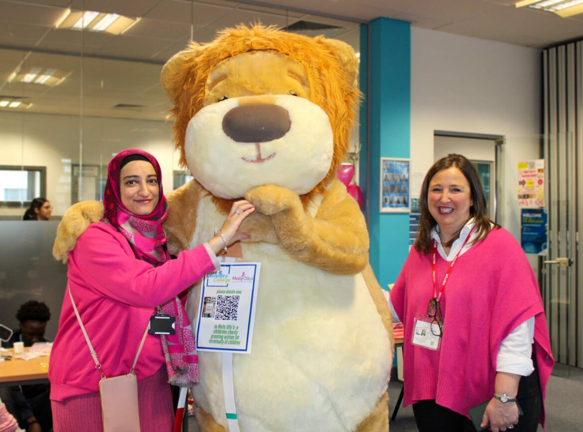 Staff members with Molly Olly's bear mascot