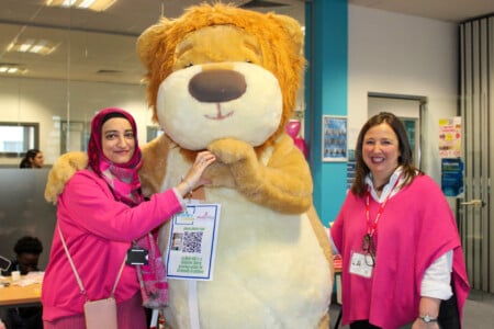 Staff members with Molly Olly's bear mascot