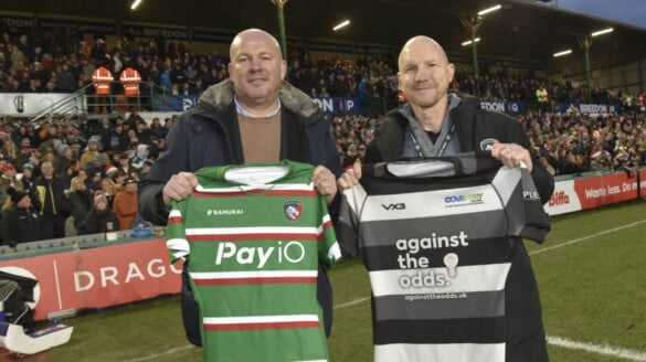 Representatives from Coventry College and Leicester Tigers holding rugby shirts