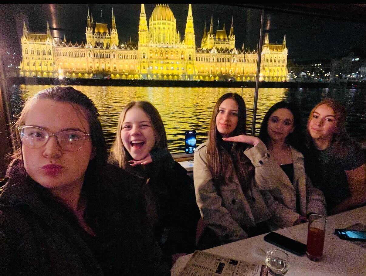 Students sat in front on building in Budapest