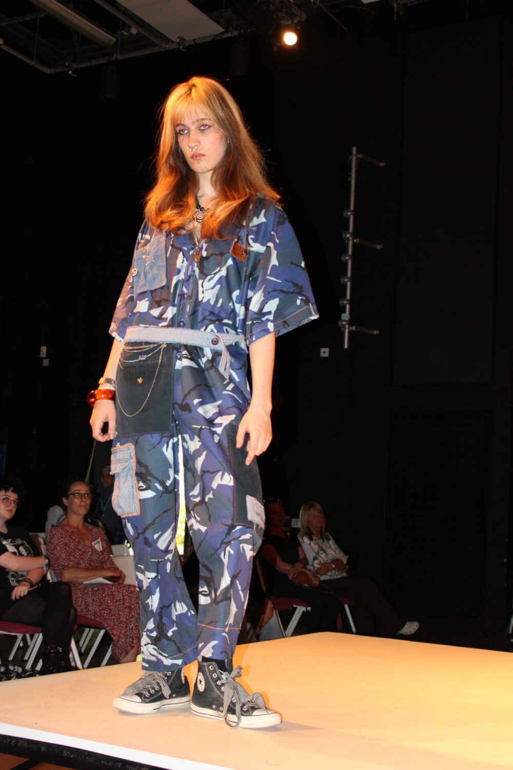 fashion student in upcycled outfit on catwalk