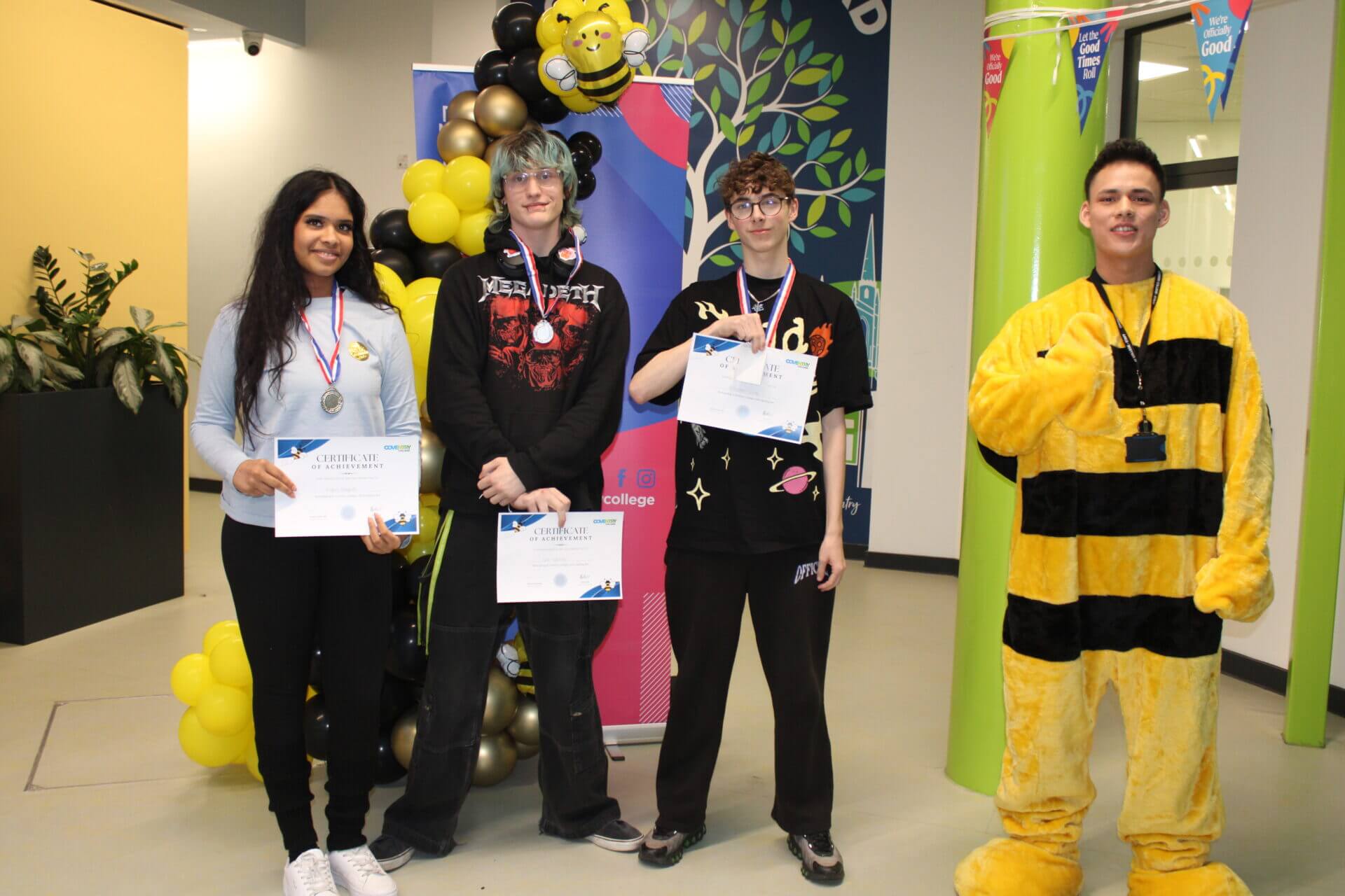 Runners up standing next to staff member dressed as bumble bee
