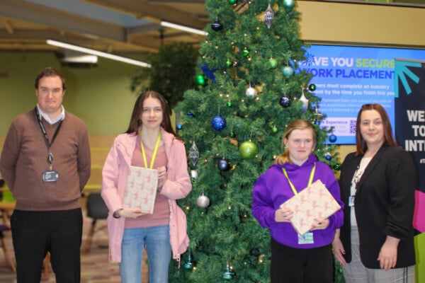 Winning students being handed their prize with Vice principal Patrick and Director Laura