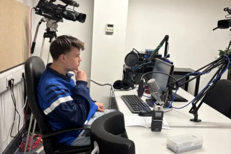 Media student sat in a radio studio