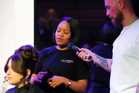 student showcasing their work on stage