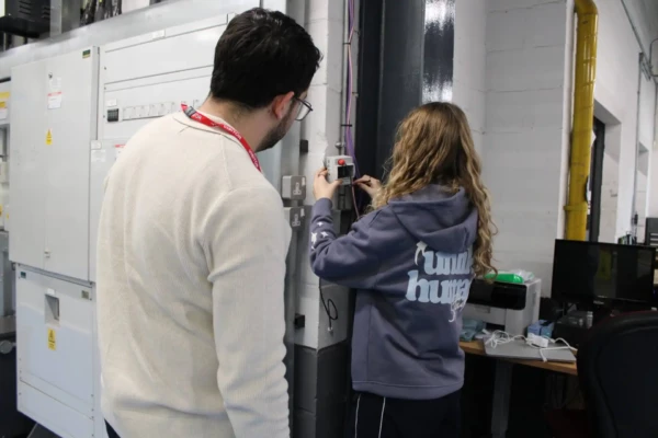 student installing piece of equipment