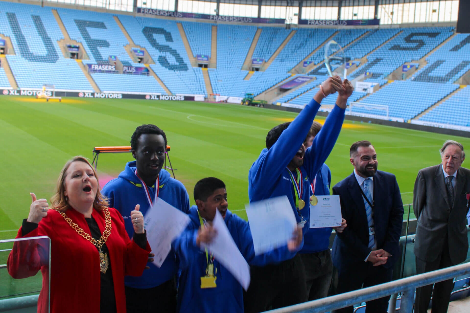 coventry college students lifting the MEI trophy