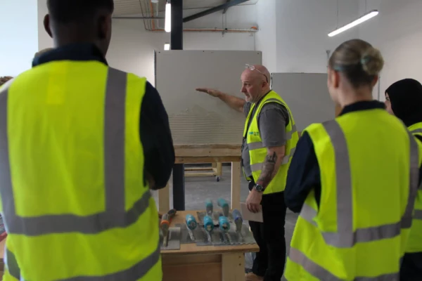 students listening to construction demonstration