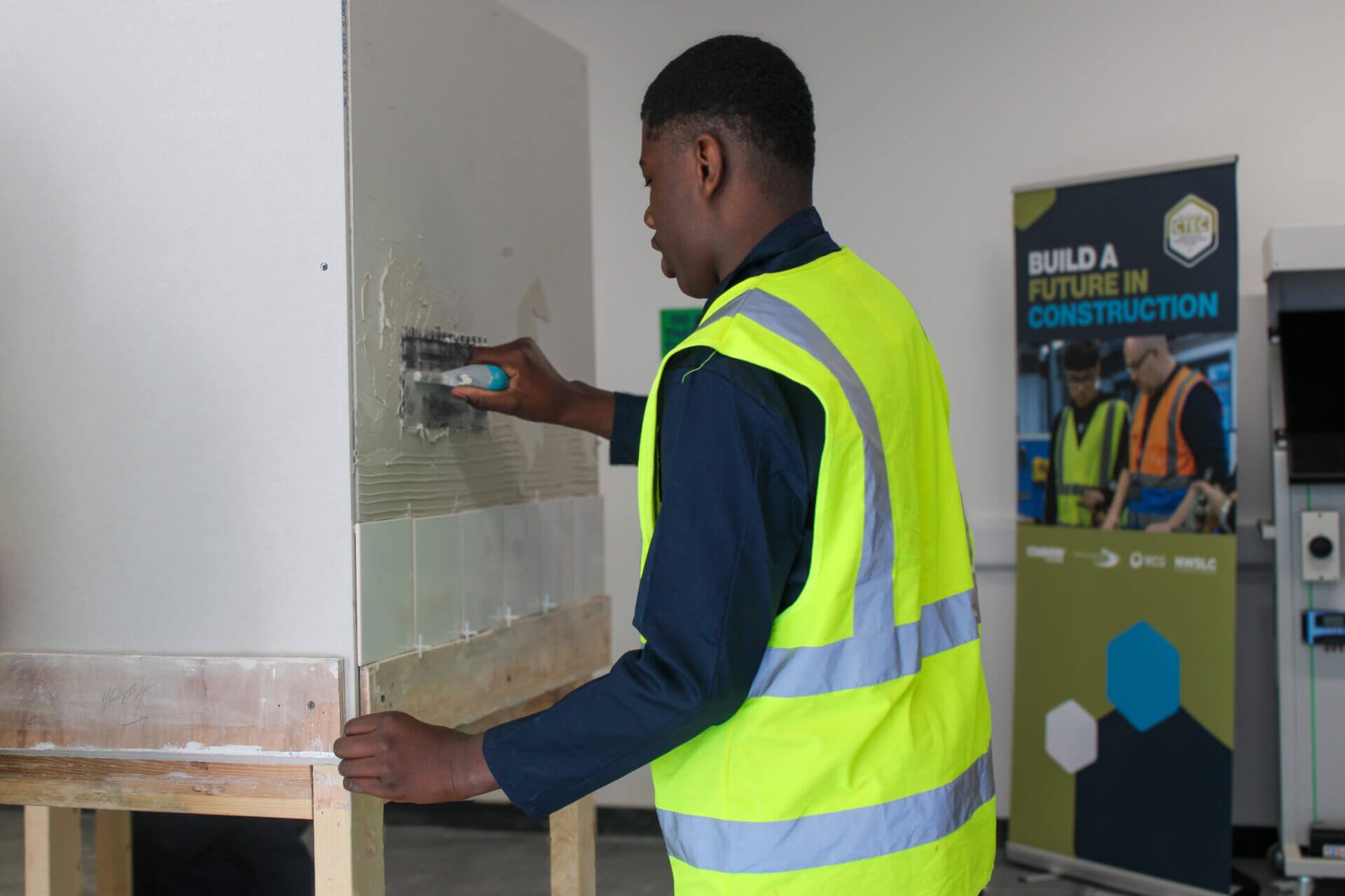 student using tiling equipment